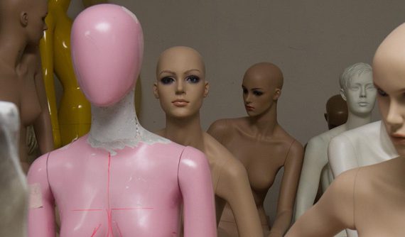 The mannequins are hand-made in the old factory. The workers daub the liquid fiberglass inside the molds and wait until it is dry. A worker can make more than ten mannequins a day.