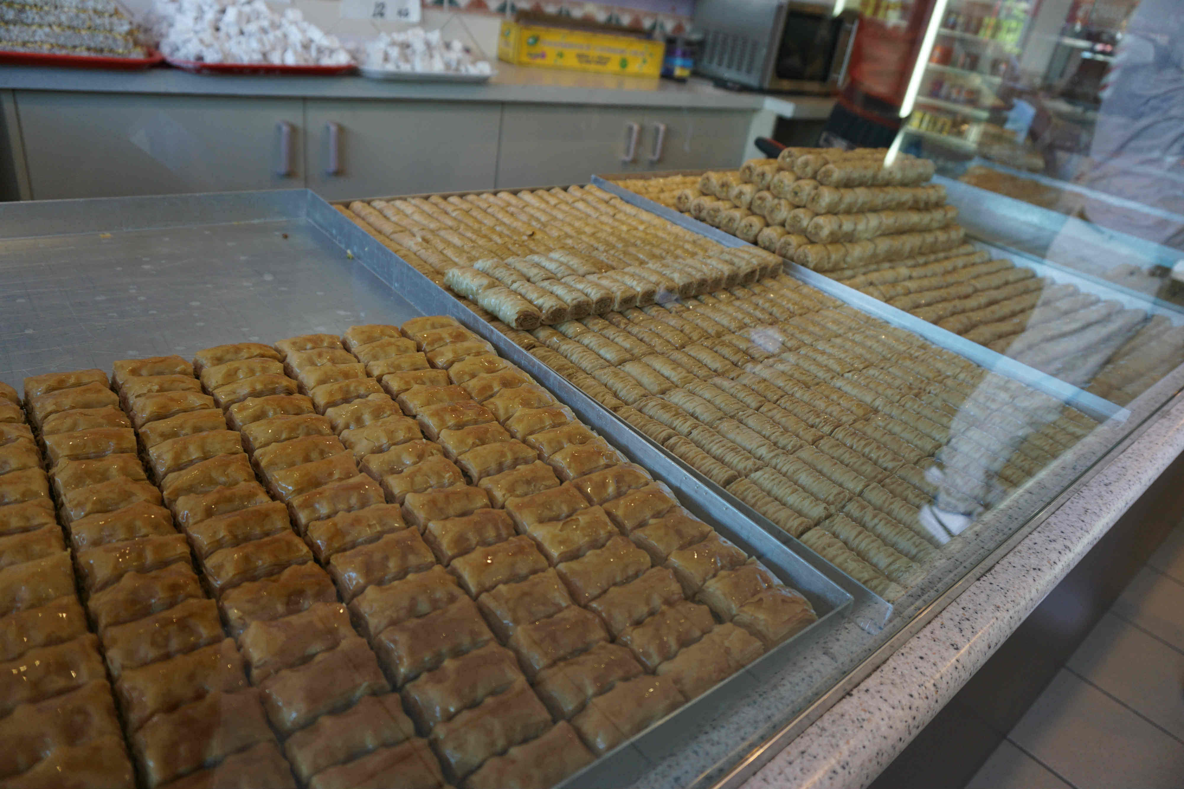  Baklava, a traditional Turkish sweets, is lined up neatly in the Al Anwar Sweets of Fairfield. This shop that's full of the smell of sweet and cream is the meeting place of the Fairfield food tour.